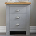  3 drawer bedside table Grey with books and a lamp on top for a cozy, functional touch.