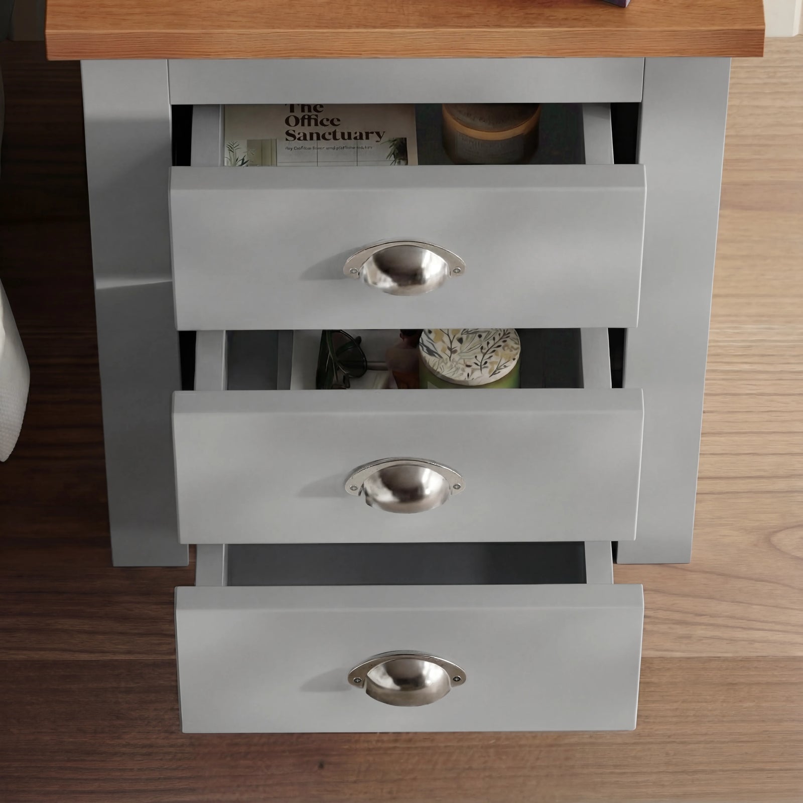 [Grey] Overhead view of grey shaker bedside with all 3 drawers cascade-open showing magazine and bowl