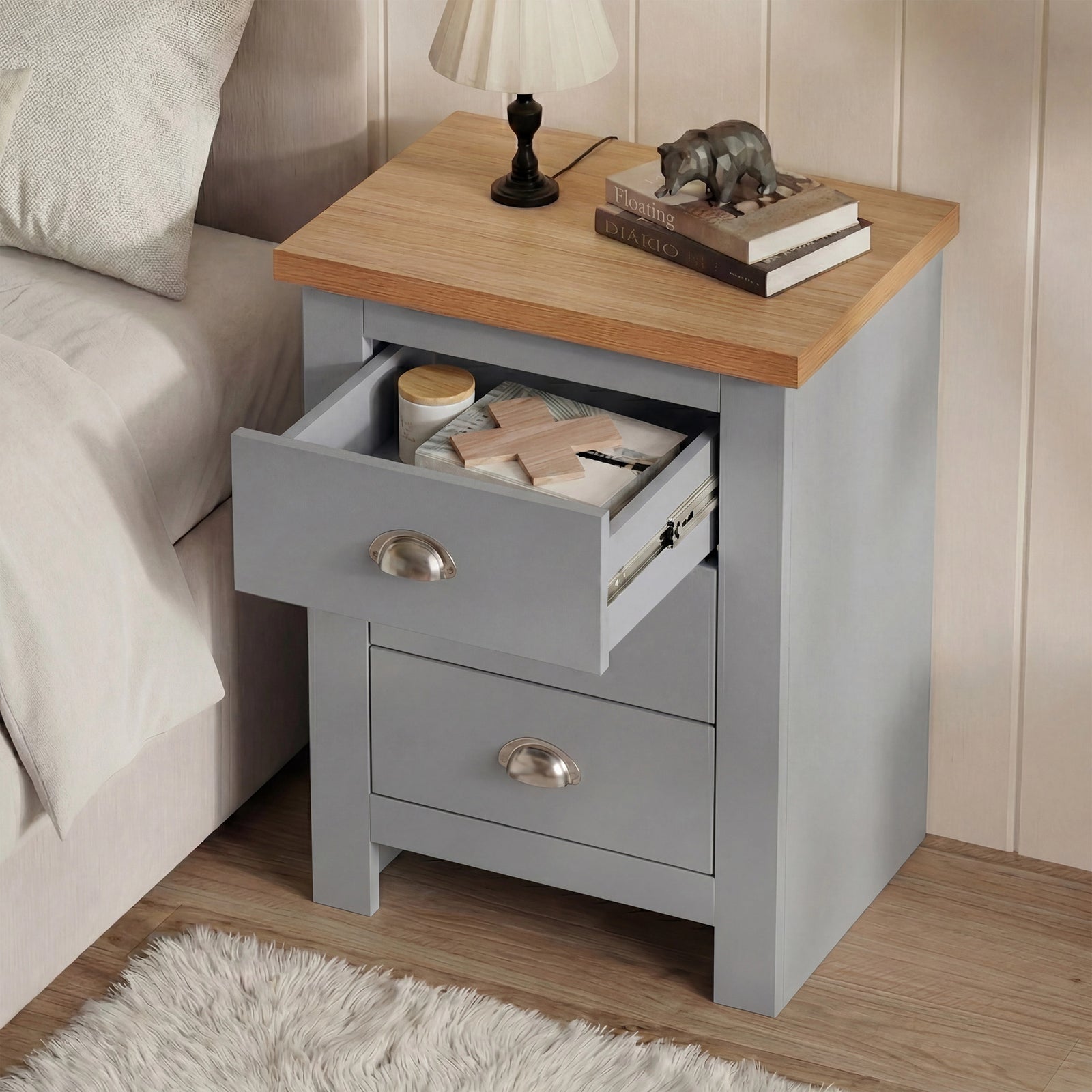 [Grey] Top drawer of grey shaker nightstand extended forward, white shag rug visible on bedroom floor