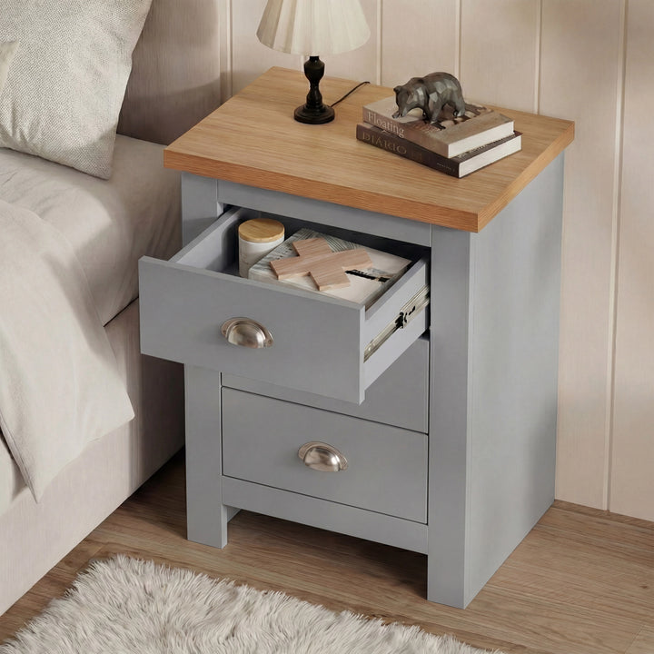 [Grey] Top drawer of grey shaker nightstand extended forward, white shag rug visible on bedroom floor