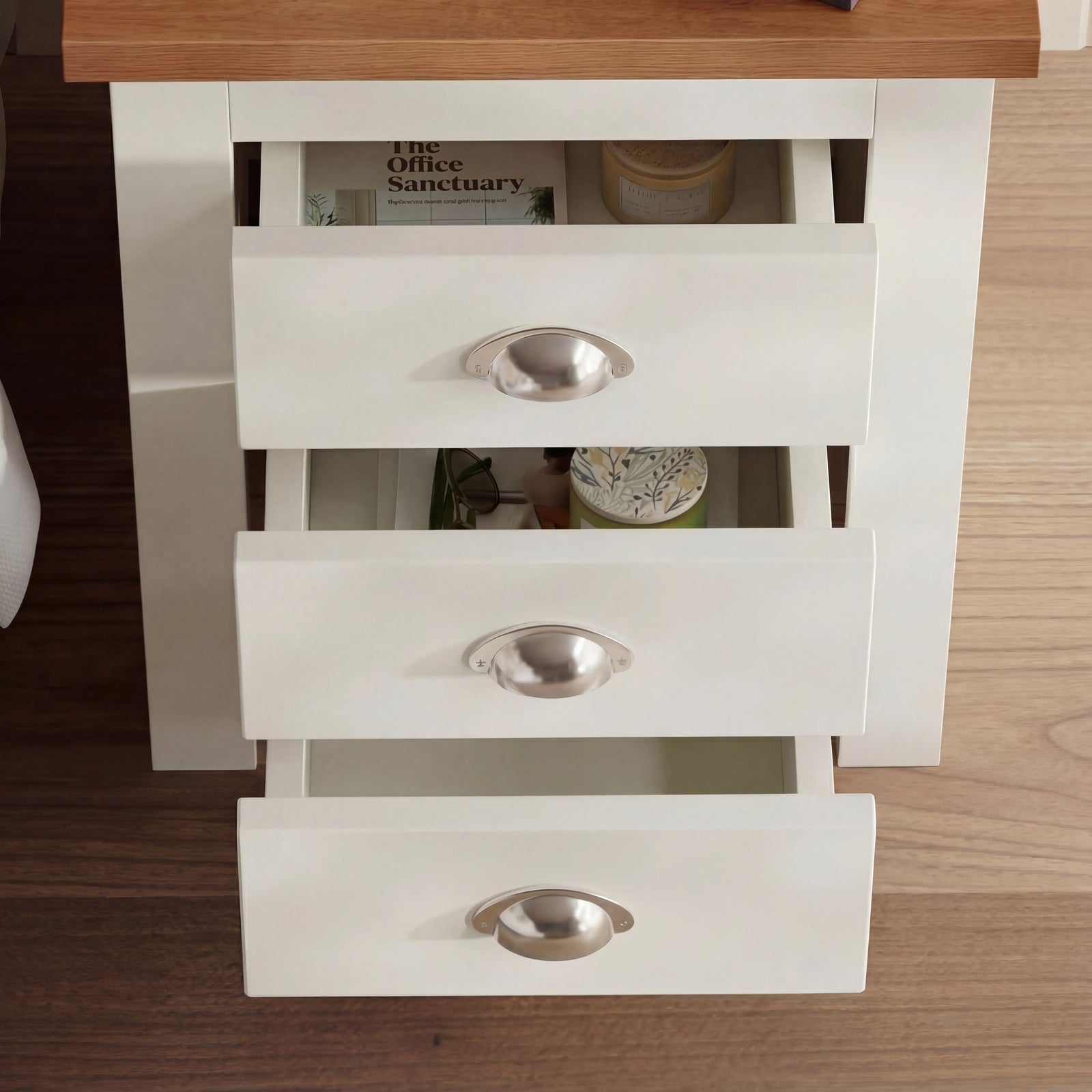 [White] Overhead angled view with all three drawers pulled open showing storage capacity and items inside