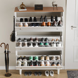 Three door shoe storage cabinet in white oak top open showing 24 shoes, mix of boots, shoes and wellies, music system on top.