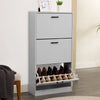 [Light Grey] Tall light grey shoe cabinet, framed art on top, bottom drawer tipped open showing footwear