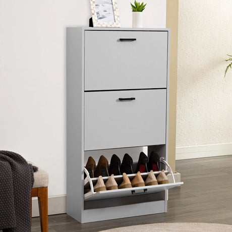 [Light Grey] Tall light grey shoe cabinet, framed art on top, bottom drawer tipped open showing footwear