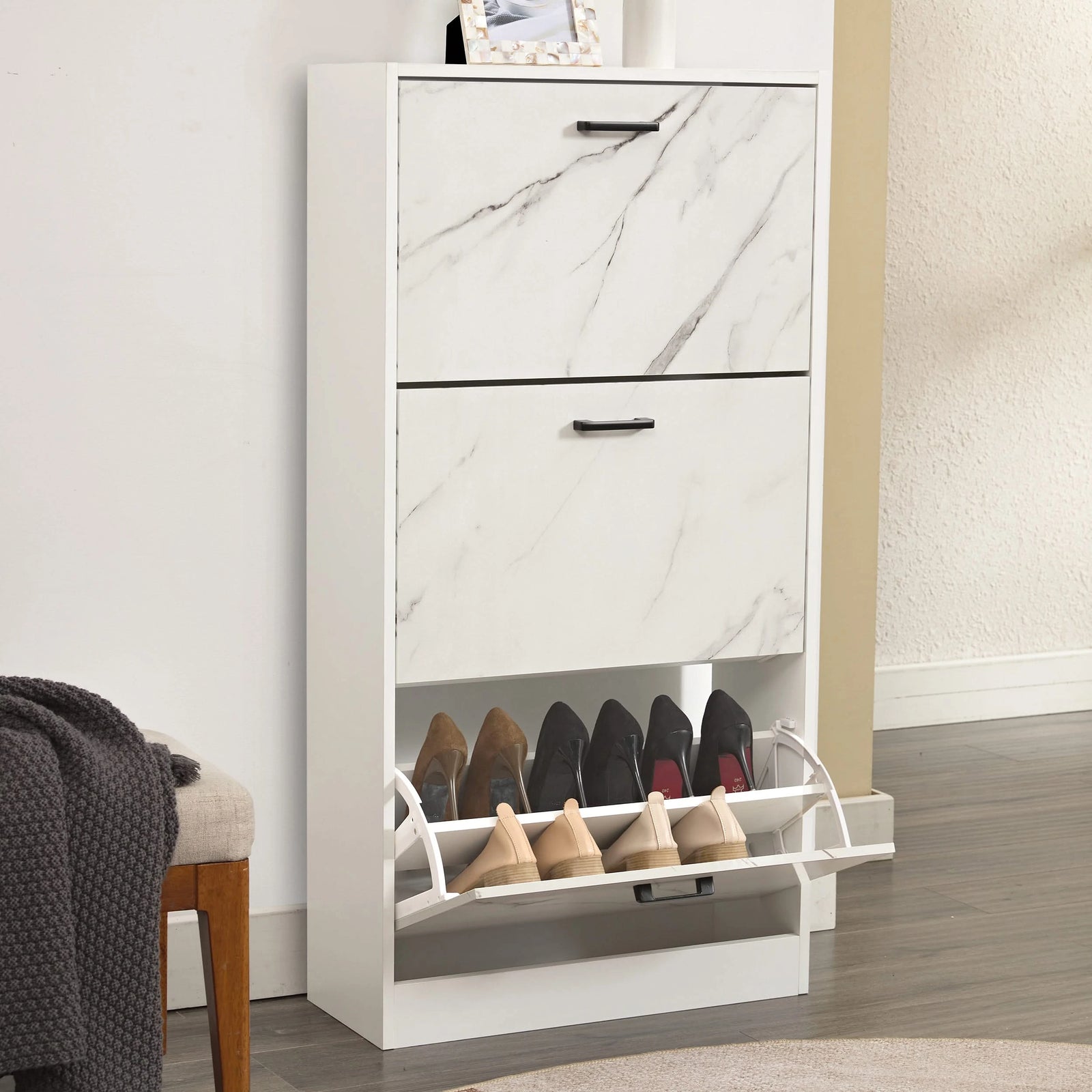 [White Marble] Glossy white marble shoe cabinet in hallway, lowest drawer tipped forward showing two rows of shoes