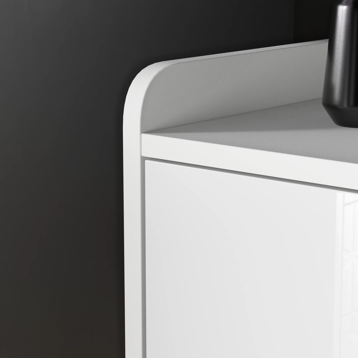 White cabinet with a black vase on a dark gray background