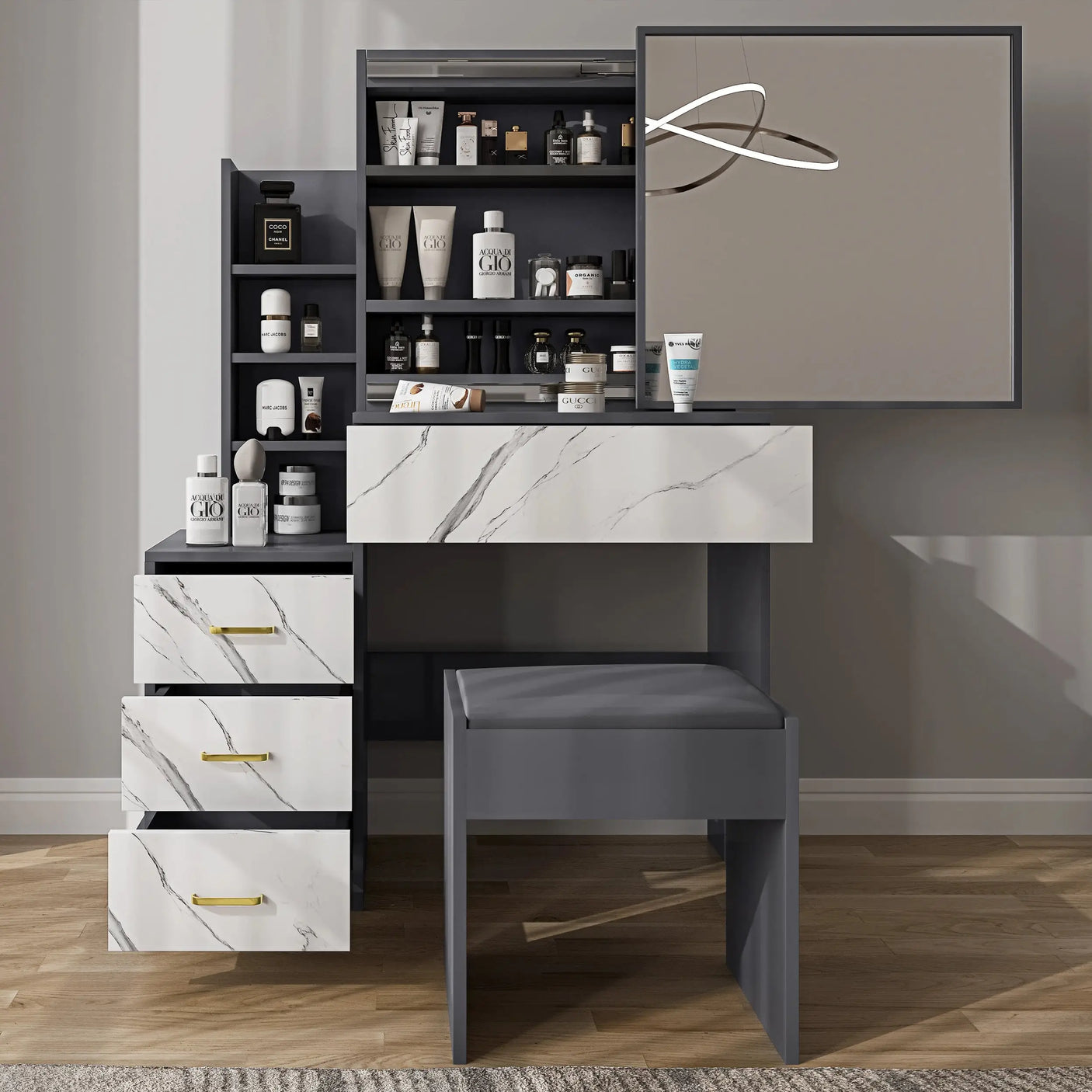 Vanity makeup table in grey with marble-style drawers and large mirror. Includes ample storage with open shelves and cushioned stool for bedroom use.