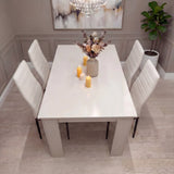 White 4 seater dining table and chairs set with PU leather upholstery, arranged in a neutral-toned room for modern dining.