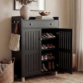 [Black] Hallway black shoe storage cabinet with one slatted door swung open to reveal stacked shoe shelves