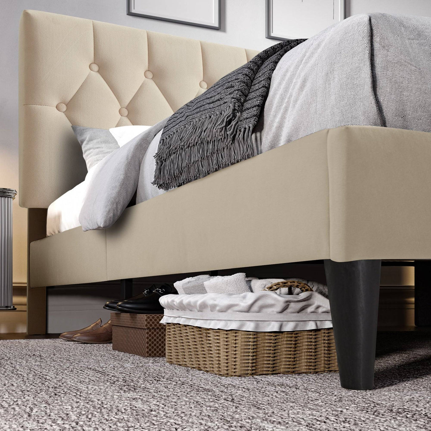 Close-up of under-bed storage space beneath Blisswood Chesterfield cream bed frame with black legs and soft velvet finish.
