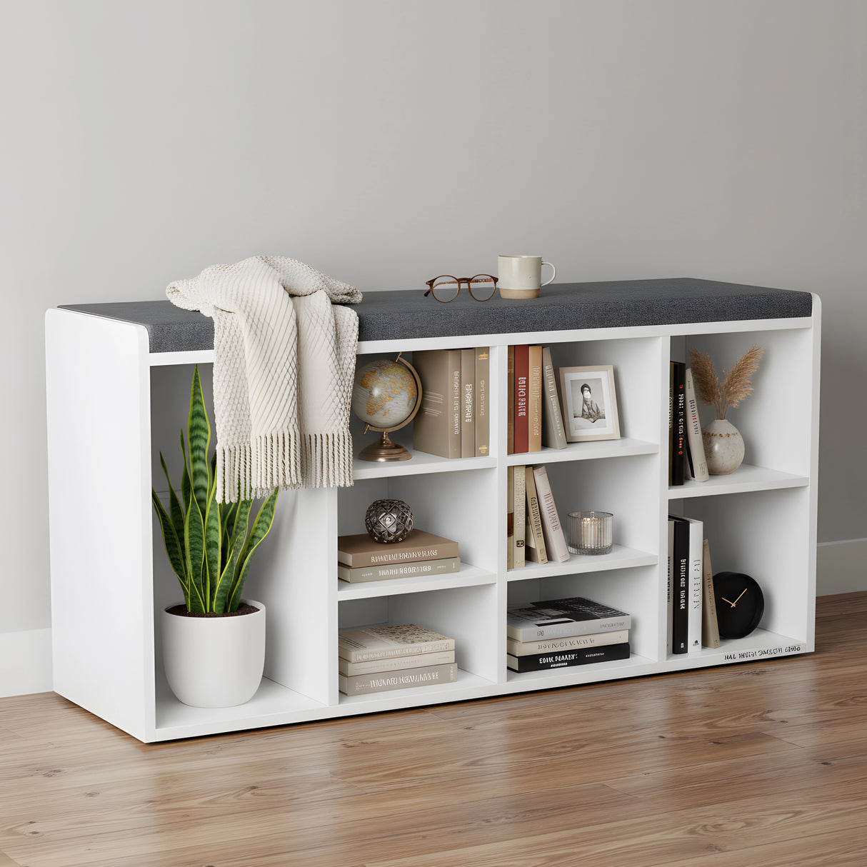 White bookshelf with gray top shelf against a plain wall