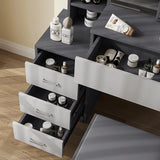Close-up of grey vanity table with light grey drawers. Organised makeup and skincare storage in a modern bedroom vanity setup.