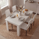 Top view of compact white dining table set for 4 with white PU leather chairs, styled for cozy and modern dining areas.