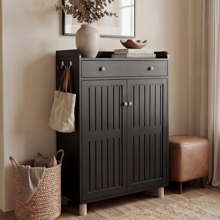 [Black] Front view of shoe cabinet with both slatted doors closed and decorative vase with bowl on top