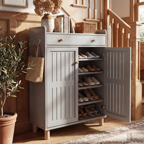 [Grey] Shoe storage cabinet with right door open showing 5 tiers of shelving filled with shoes in hallway beside staircase