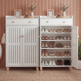 [White] Shoe cabinet in use with one louvered door open and shoes visible on adjustable shelves in styled entryway