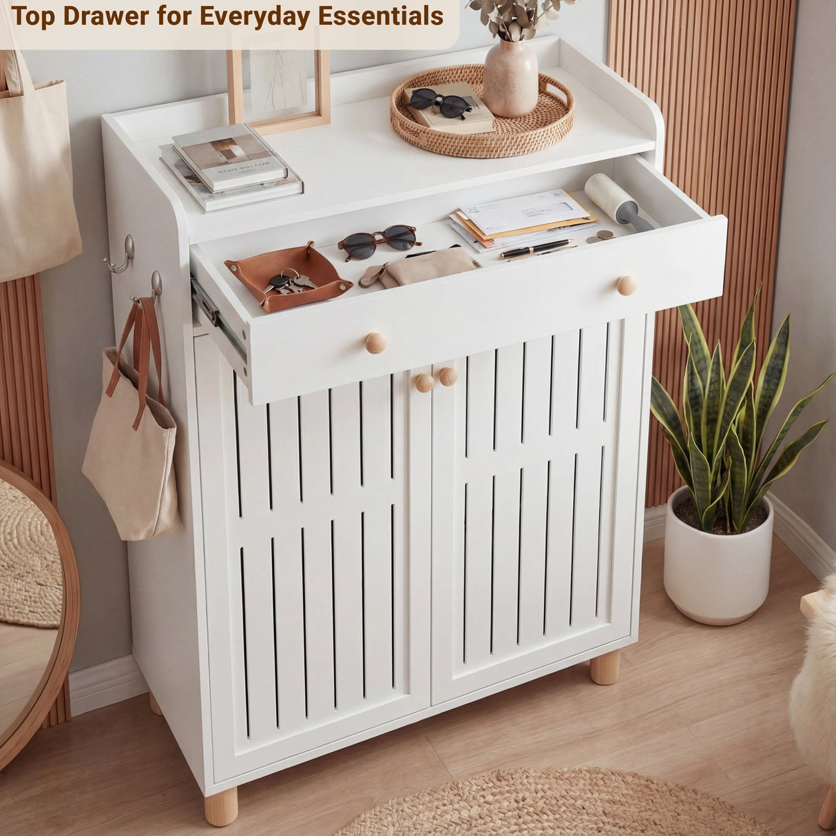 [White] Top drawer pulled open showing everyday essentials like sunglasses wallet and keys with rattan tray on surface