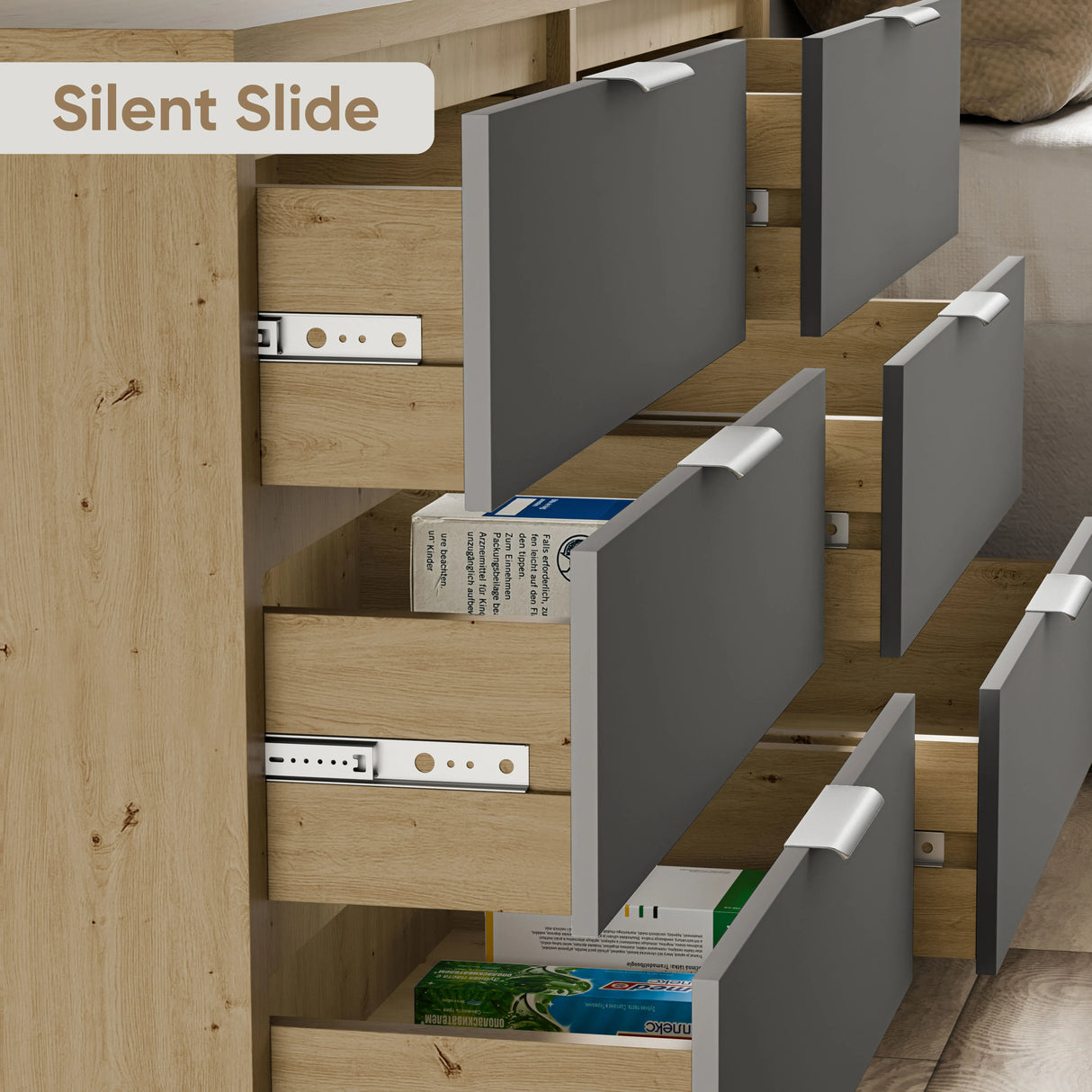 Close-up of partially open 6 chest of drawers in two-tone finish, highlighting silent slide runners with metallic handles