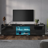 Modern black TV stand with a blue illuminated shelf in a living room setting.