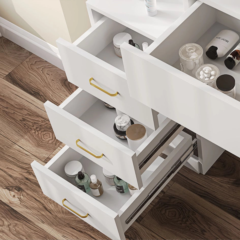 Close-up of white vanity table drawers with gold handles. Organized storage for cosmetics and skincare in a modern bedroom setup.