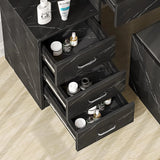 Close-up of black vanity table drawers with marble finish. Organized storage for cosmetics and skincare in a modern bedroom setup.
