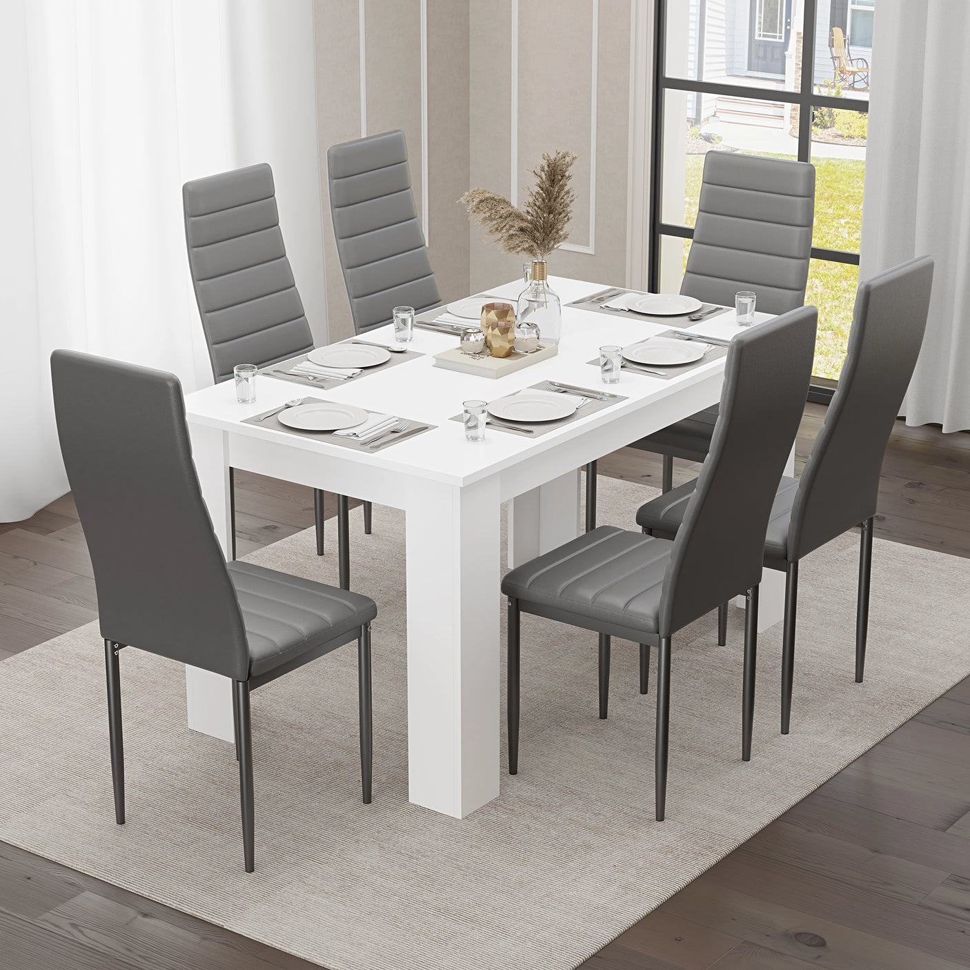 Dining table set 6 seater – White table with six grey padded chairs, perfect for modern dining rooms or open-plan kitchens.