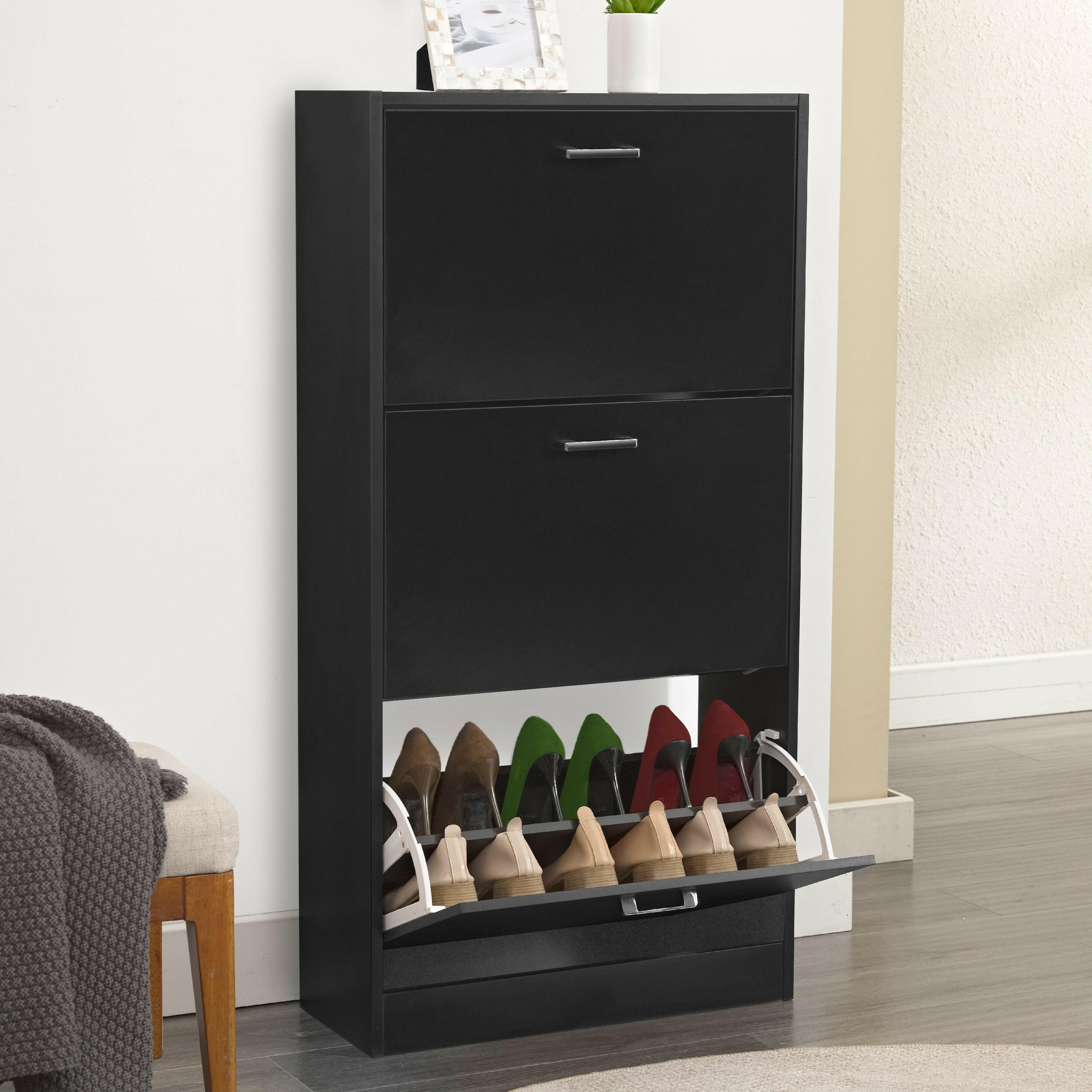 Black slim shoe cabinet with two drawers and a lower compartment for organized shoe storage.