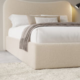 Curved headboard ottoman storage bed in beige boucle fabric with hidden under-bed storage. Stylish platform bed frame ideal for modern bedrooms.