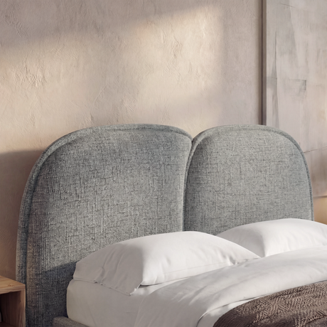 Wooden grey double bed frame featuring a comfortable, soft headboard and neutral bedding in a modern bedroom setup