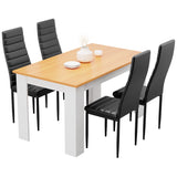 Warm pine dining table with white legs and 4 black PU leather chairs. Space-saving dining set for small homes.