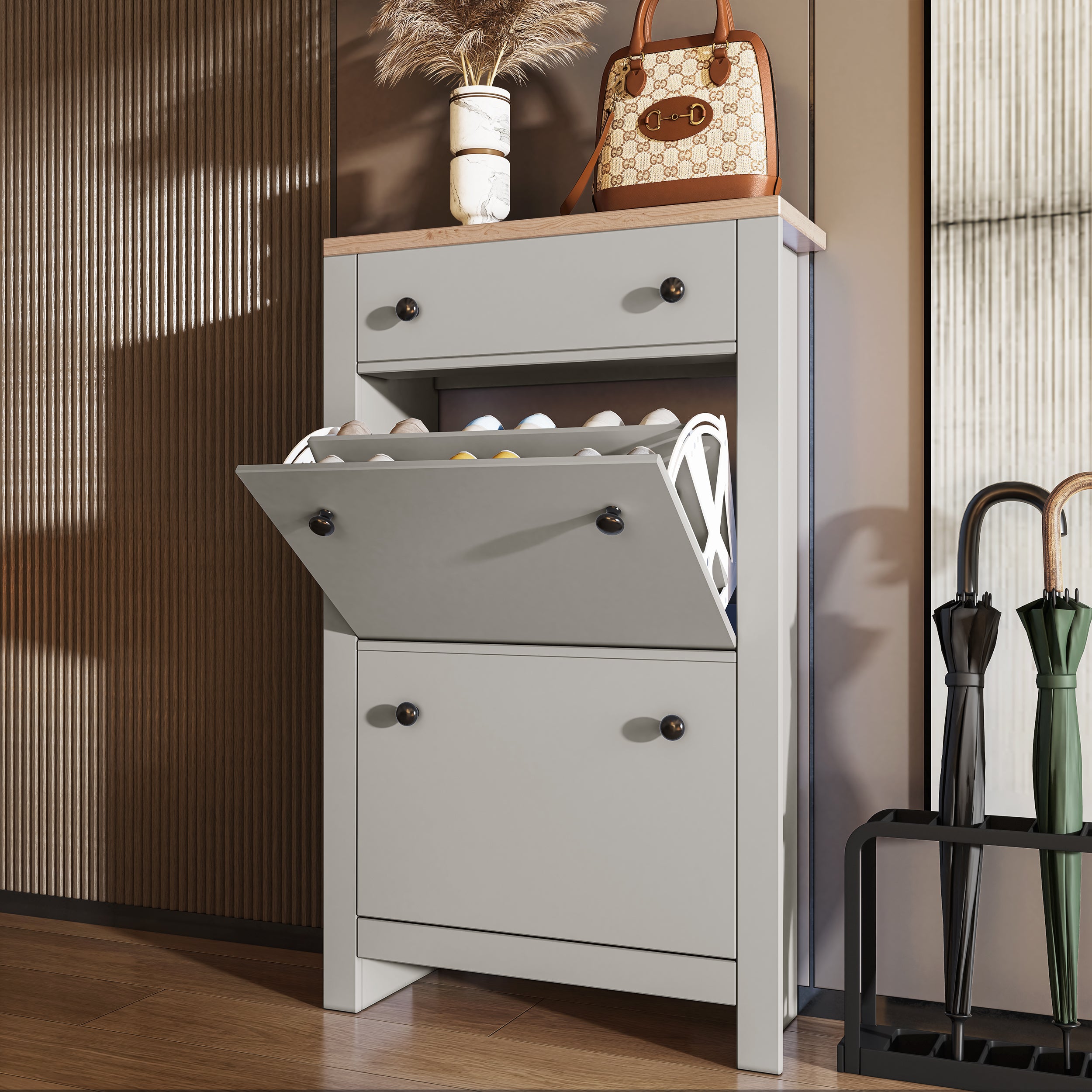 Oak shoe cabinet with drawer and multiple flip-up compartments for organized shoe storage.