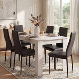 Modern 4-6 seater white dining table and chairs set with black PU leather chairs in a bright dining room, ideal for contemporary kitchens.