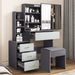 Grey vanity table with light grey drawers, mirror, and stool. Features multiple storage compartments for makeup and accessories.