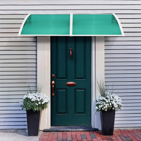 Green polycarbonate canopy with white frame above front door canopy for weather protection.