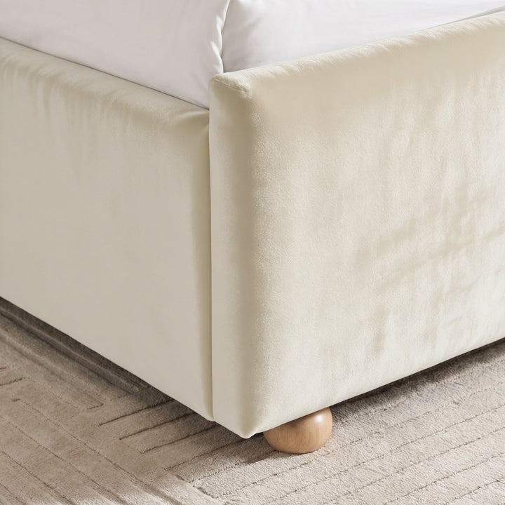 [Beige | Double] Close-up of beige plush velvet footboard corner, raised side rail and low round wooden foot