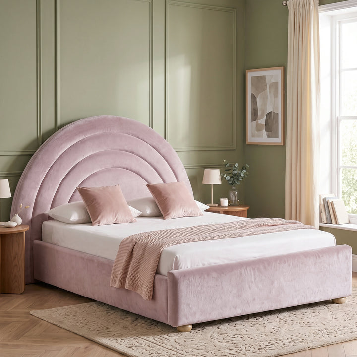 [Pink | Double] Double pink rainbow ottoman bed in styled bedroom with arch headboard, side table and window