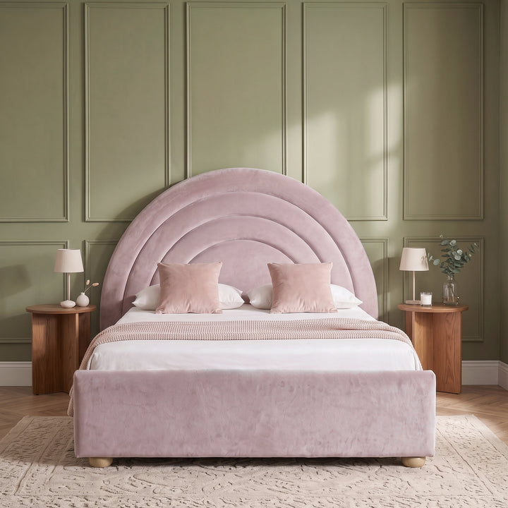 [Pink | Double] Front view of pink plush velvet rainbow ottoman bed with concentric arch headboard and wooden feet