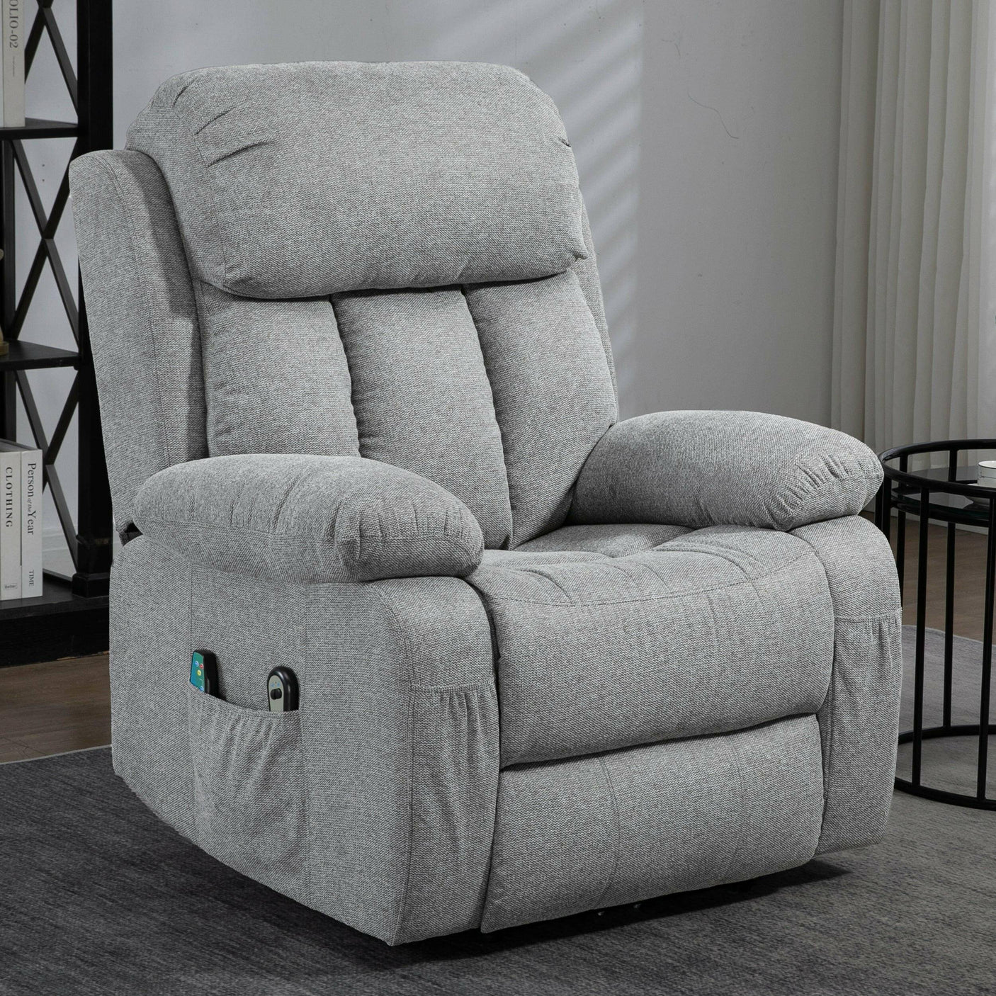 Grey fabric recliner armchair with plush cushioning and side pockets, ideal for living rooms or bedrooms. Stylish and functional seating.