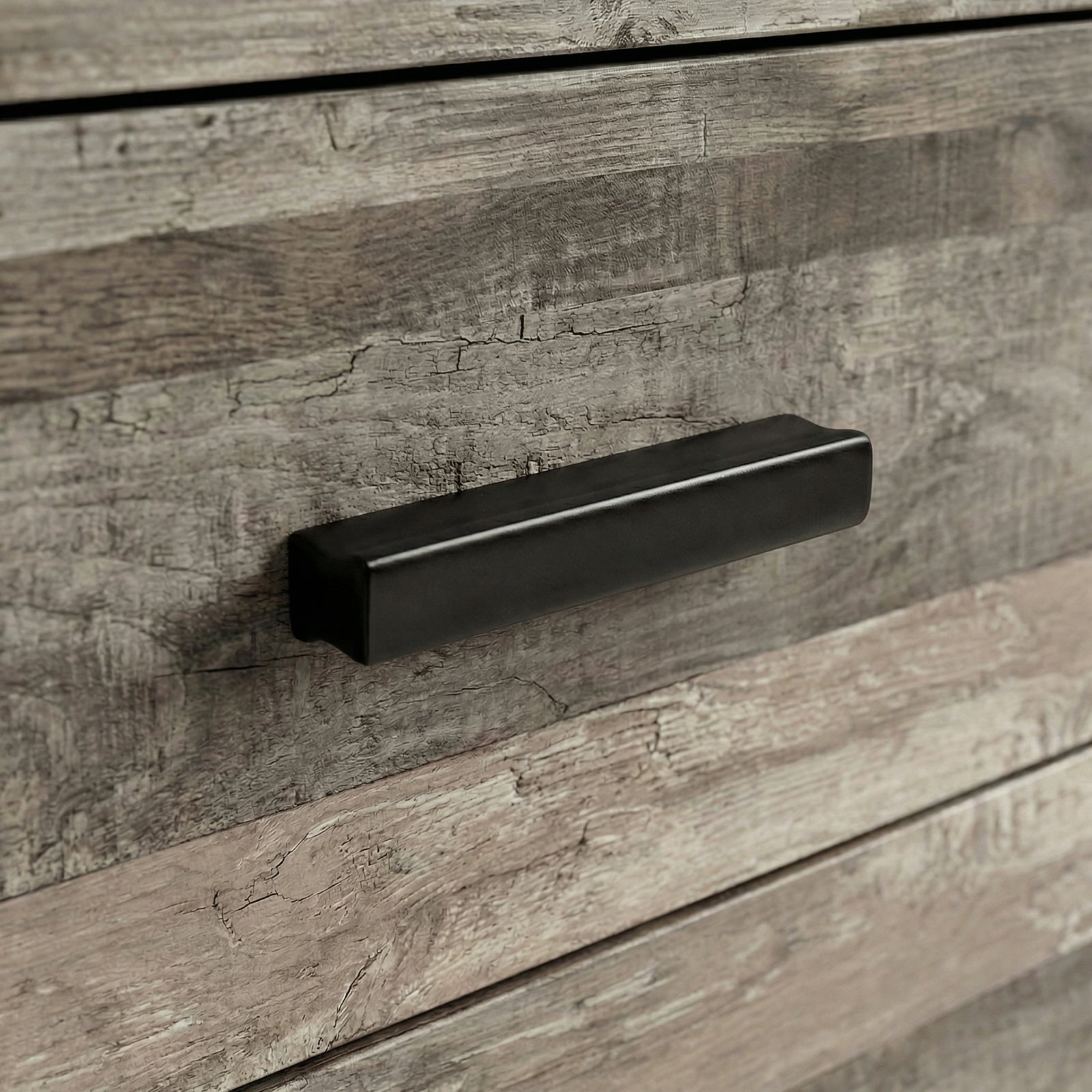 [Ash Grey] Close up of ash grey drawer front with matte black wooden handle and textured wood grain surface