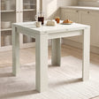 [Ash White] Closed square flip-top dining table with steel hinges, styled with a French press, mug, honey and croissant.