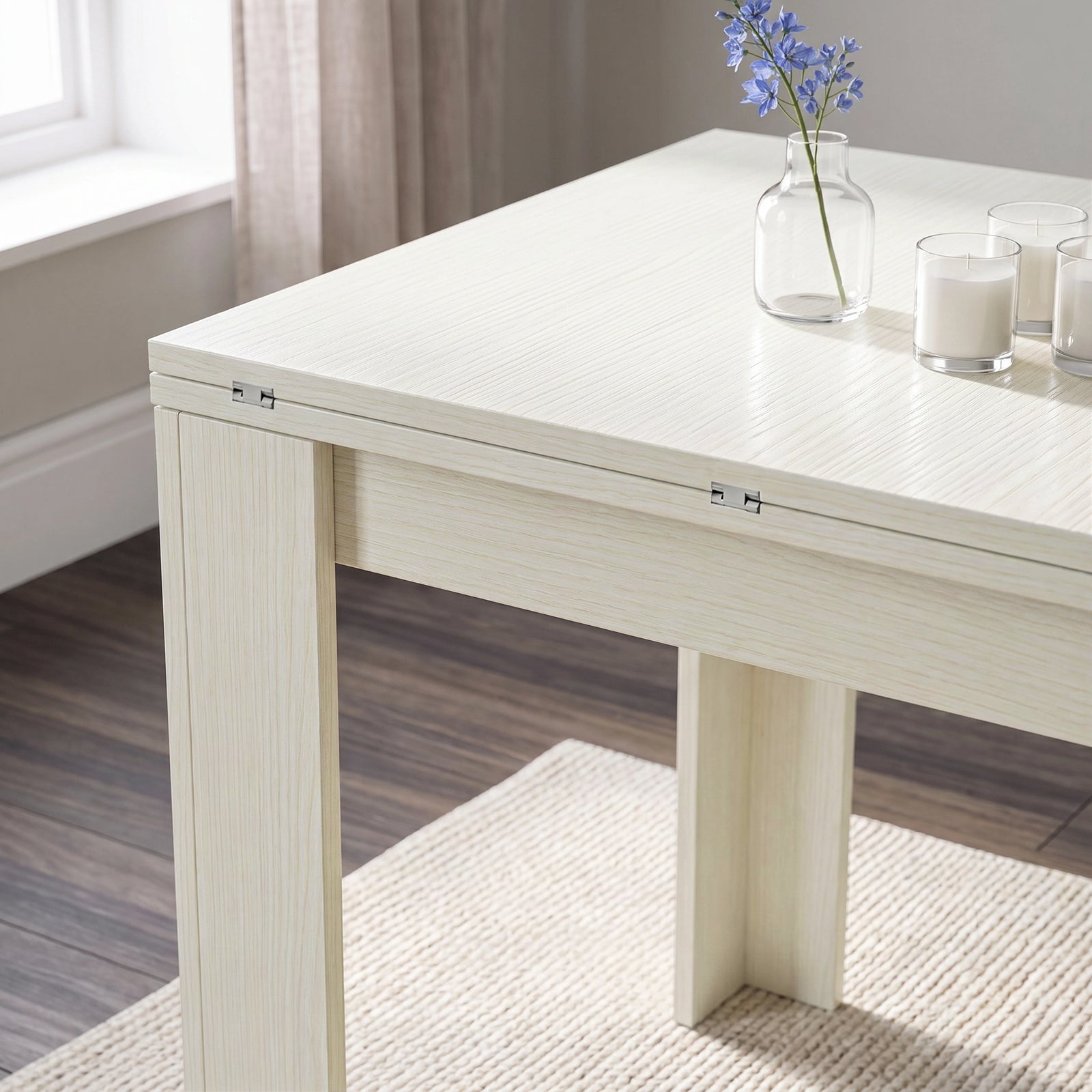 [Ash White] Close-up of the folded flip-top dining table showing the wood-effect tabletop, steel hinges and wide legs.