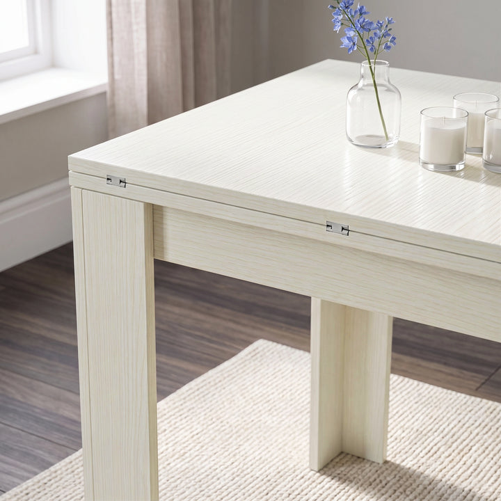 [Ash White] Close-up of the folded flip-top dining table showing the wood-effect tabletop, steel hinges and wide legs.