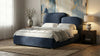 [Double | Blue] Modern bedroom with a blue upholstered bed, nightstands, and abstract wall art.
