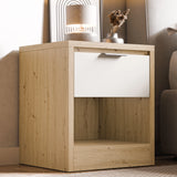 Modern bed side drawer in light timber finish with open shelf placed near a bed in a modern bedroom