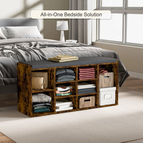 Hallway shoe storage bench with cushion & adjustable shelves in rustic wood finish, placed at the foot of a bed for bedroom storage use.