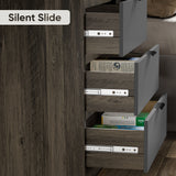 Close-up of three partially open bedroom chest of drawers, in a two-tone finish with the smooth metal drawer runner hardware