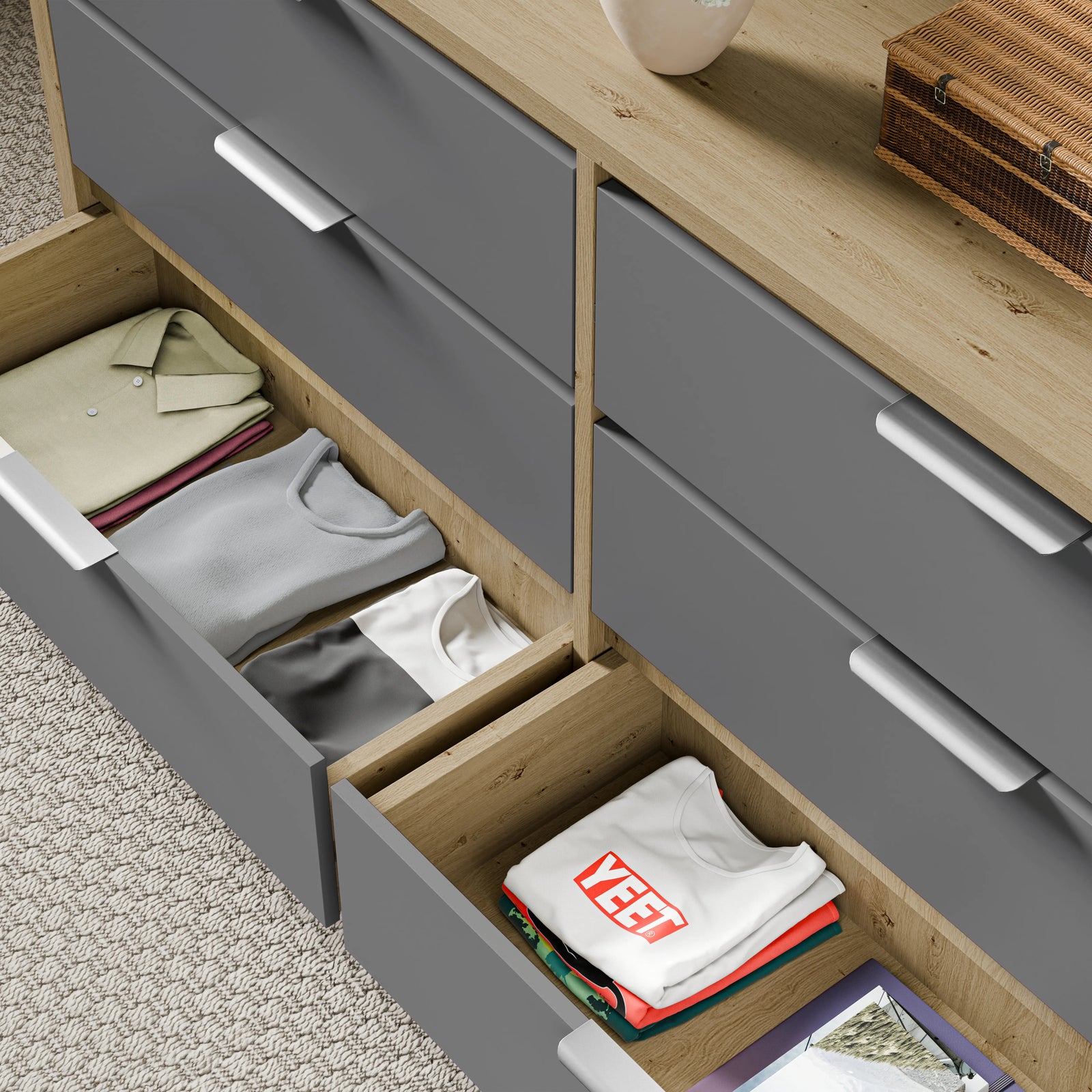 Wooden grey finish bedroom drawers showing two lower drawers opened with a neatly folded stack of clothes
