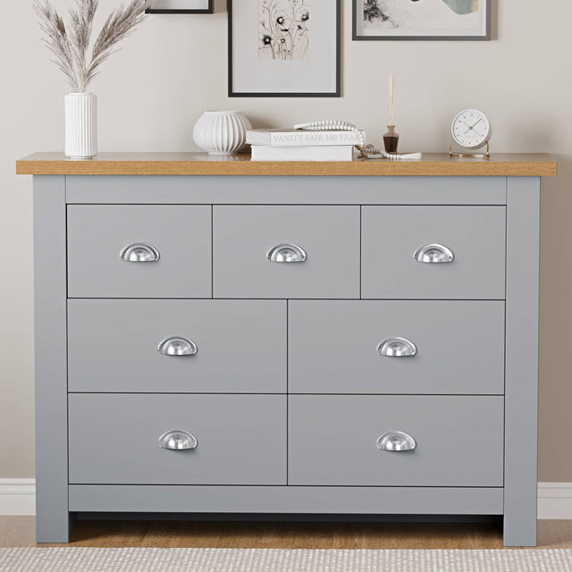 Bedroom furniture chest of drawers with top surface for flower pots, offering storage and decor.
