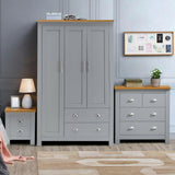 Grey bedroom furniture set with wardrobe, chest of drawers, bedside table.