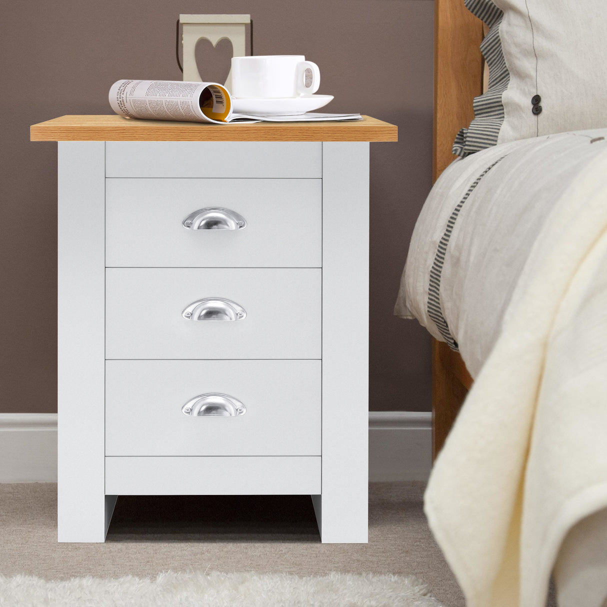 bedside table white with oak top, chrome handles, and three spacious drawers for storage.